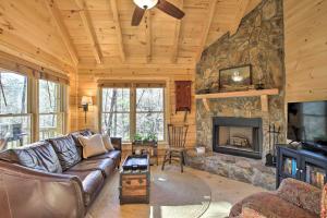 a living room with a couch and a fireplace at Couples Getaway Cabin by Hiking and Waterfalls! in Cherry Log