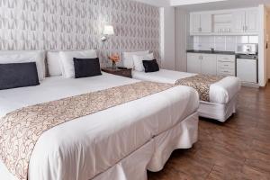 En eller flere senger på et rom på Ker Belgrano Hotel