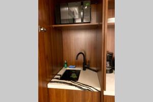 a kitchen with a sink and a microwave at 3E-Cozy! Micro apartment! in Oakland, sleeps 1 in Pittsburgh