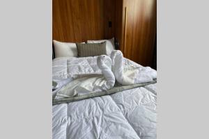 an unmade bed with white sheets and pillows at 3E-Cozy! Micro apartment! in Oakland, sleeps 1 in Pittsburgh