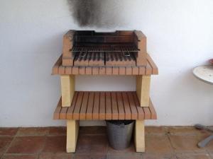 a wooden bench sitting next to a wall at Casa Olivo in Perelló