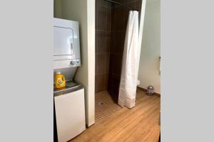 a small bathroom with a refrigerator and a shower at 3E-*New* Apartment -5 min from Downtown, sleeps 4 in Pittsburgh