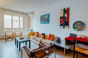 a living room with a couch and a table at Grand Central Ventimiglia - WiFi & Parking in Ventimiglia