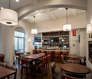 a restaurant with tables and chairs and a bar at Holiday Inn Manhattan 6th Ave - Chelsea by IHG in New York