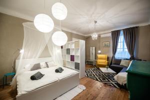 a bedroom with a canopy bed and a living room at Boutique B&B Mali Pariz in Crikvenica +91 photos