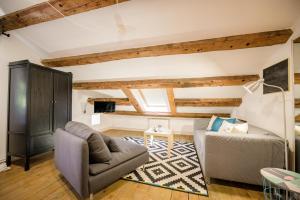 a living room with a couch and a chair at Boutique B&B Mali Pariz in Crikvenica