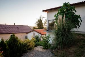 a house with a garden in front of it at Boutique B&B Mali Pariz in Crikvenica