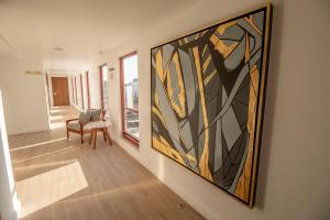 a room with a large painting on the wall at Six Hotel Guadalajara Degollado in Guadalajara