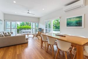 a dining room and living room with a table and chairs at Location, location, Sunshine Beach in Sunshine Beach