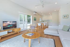 a living room with a couch and a table at Location, location, Sunshine Beach in Sunshine Beach