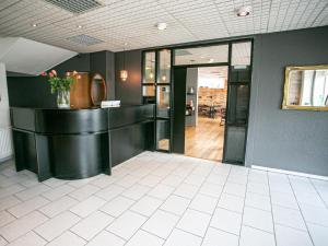 an empty lobby with a reception desk in a building at Hotel Norðurland in Akureyri