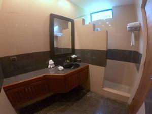 a bathroom with a sink and a mirror at Suite 9, Manuel Antonio in Quepos +22 photos