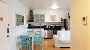 a kitchen with a table and chairs and a couch at SOBE SUNSHINE ONE BEDROOM APARTMENTs in Miami Beach