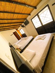 a bedroom with a large bed and a window at Hotel Mirador de Santa Bárbara in Socorro