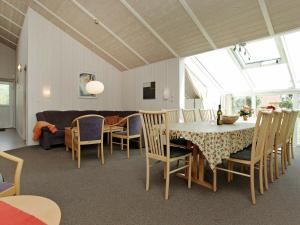 a dining room with a table and chairs at Four-Bedroom Holiday home in Otterndorf 13 in Otterndorf