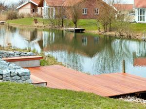 オッテルンドルフにある12 person holiday home in Otterndorfの湖の中の木造桟橋