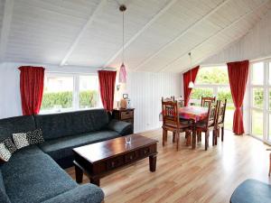 a living room with a couch and a table at 6 person holiday home in Gelting in Gelting