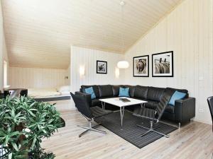 a living room with a couch and a table at 8 person holiday home in Gro enbrode in Großenbrode