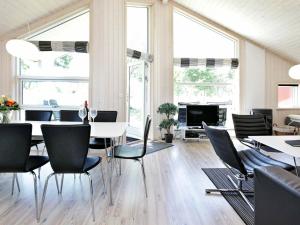 a dining room with a table and chairs at Three-Bedroom Holiday home in Großenbrode 7 in Großenbrode