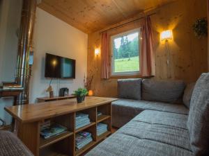 a living room with a couch and a table at Chalet in Annaberg-Lungötz with terrace in Annaberg im Lammertal