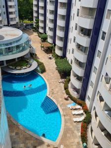 an overhead view of a swimming pool between two buildings at Rio Quente Aguas da Serra Apart in Rio Quente
