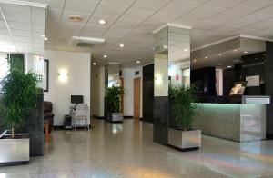 a lobby with potted plants in a building at Hotel Villa Naranjos in Jávea