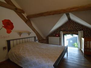 una camera da letto con un grande letto in mansarda di Spacious house in a farm located in the bucolic a Teuven