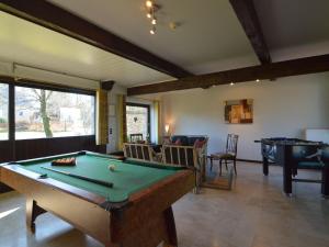 a billiard room with a pool table and a table at Alluring Cottage in Waimes - Robertville with Sauna in Waimes