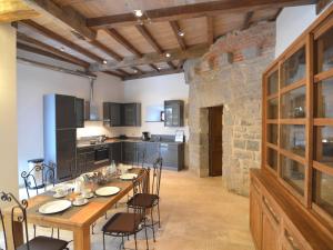 a kitchen with a long wooden table and chairs at Modern Holiday Home in Senzeille with Garden in Senzeille