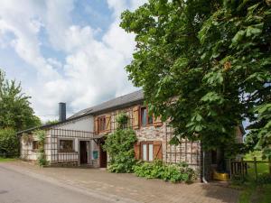RoumontにあるHeritage Holiday Home in Roumont with Private Gardenの木の前の古い石造家