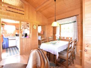 a kitchen and dining room with a table and chairs at Serene Holiday Home in K gsdorf with Sea View in Kägsdorf