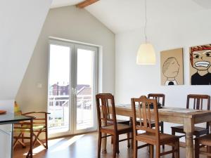 a dining room with a wooden table and chairs at Exklusive Panoramawohnung in Barth in Barth