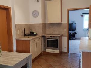 a kitchen with a sink and a stove top oven at Cozy Apartment in Satow Kuhlungsborn and Doberan with garden in Satow
