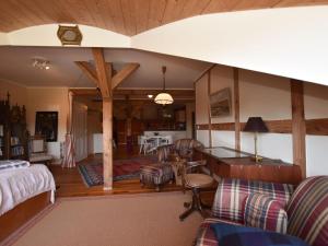 a living room with a couch and a table at Buschenhagen Rustic Getaway in Buschenhagen