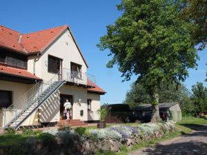 a man standing on the steps of a house at Apartment in Starigrad with Terrace, Garden, BBQ, Parking in Klein Nienhagen