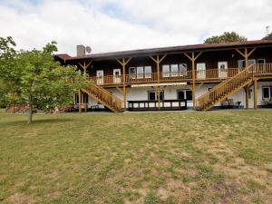 a large building with wooden stairs and a grass field at Expansive Holiday Home in Mecklenburg near Baltic Sea in Boddin