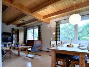 a living room with a table and chairs and a couch at Expansive Holiday Home in Mecklenburg near Baltic Sea in Boddin