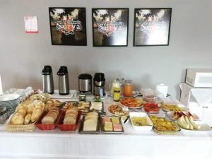 a table topped with lots of different types of food at Pousada Surya in Porto Velho +15 photos