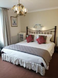 a bedroom with a large bed with red pillows at The Pier in Portsmouth