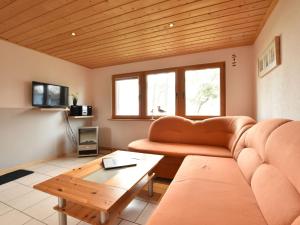 a living room with a couch and a table at Cosy Holiday Home in Am Salzhaff by the Sea in Pepelow