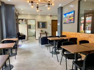 a dining room with wooden tables and chairs at Philippa's Bed and Breakfast in Iloilo City