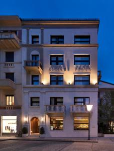 a large white building with balconies on it at Posta Design Hotel in Como
