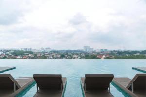 a view of a large body of water with two chairs at 1 Tebrau Residences By JK Home in Johor Bahru