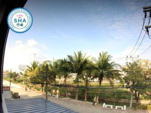 a view of a street with palm trees and stairs at P Bliss hotel in Phayao