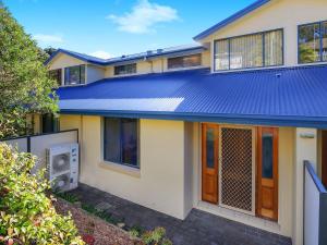 特里格爾的住宿－Family Beach Retreat in Lovely Terrigal Home，蓝色金属屋顶的房子