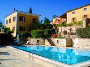 a swimming pool in front of a building at Archontiko Villas in Alykes