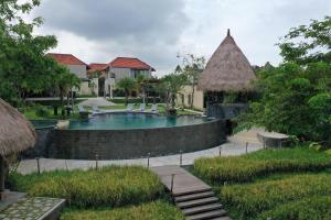 a swimming pool in the middle of a resort at Lalasa Villas Canggu in Canggu