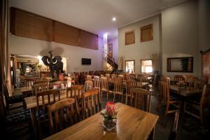 a restaurant with tables and chairs in a room at Ivory Tusk Lodge in Tzaneen