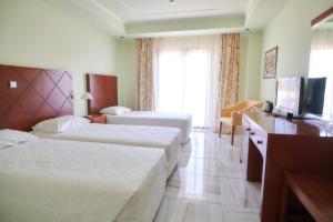 Postel nebo postele na pokoji v ubytování Nefeli Hotel