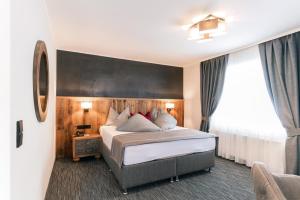 A bed or beds in a room at Waidringer Hof 4 Sterne Superior